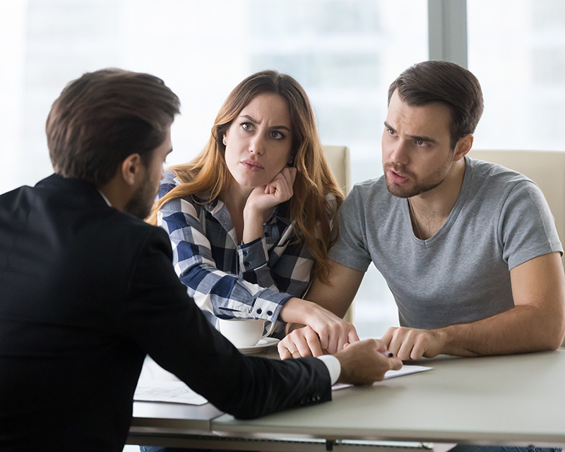 Couple speaking with attentive person