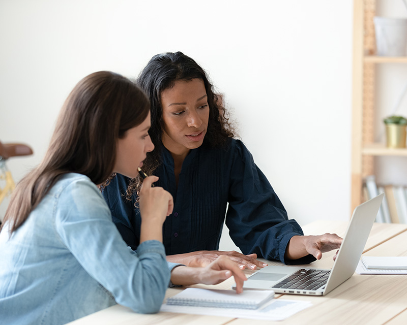 Woman pointing out something another woman may need to know; Anticipation is one of the four interventions of the eSCAPe Protocol